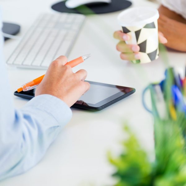 Two business woman working in office with digital tablet. Portrait of two business woman working in office with digital tablet.